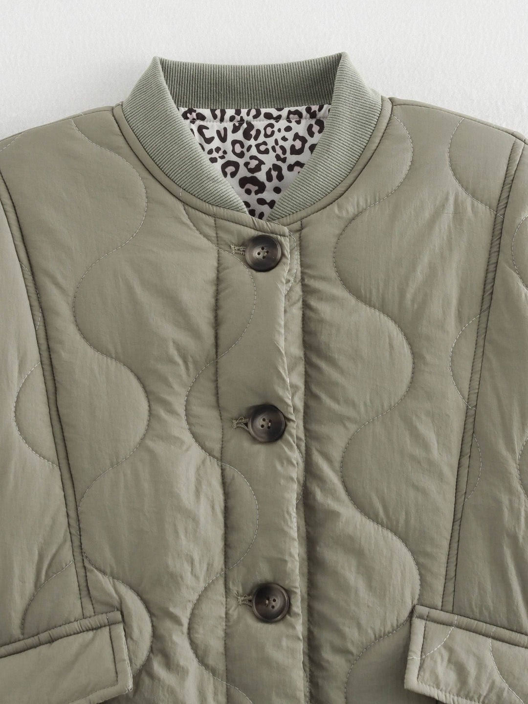 Women's quilted jacket with stand collar, button front and leopard-print cuffs