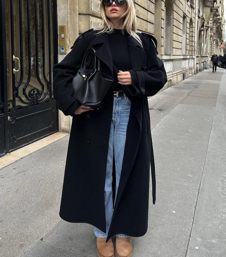 Women's black long double-breasted trench coat with lapels and waist belt