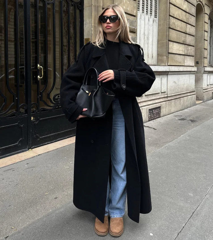 Women's black long double-breasted trench coat with lapels and waist belt