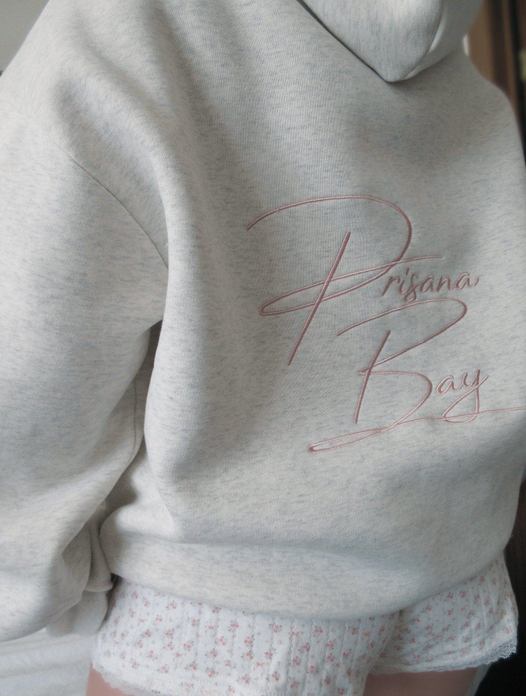 Light grey women's hoodie with floral lined hood and pink embroidery