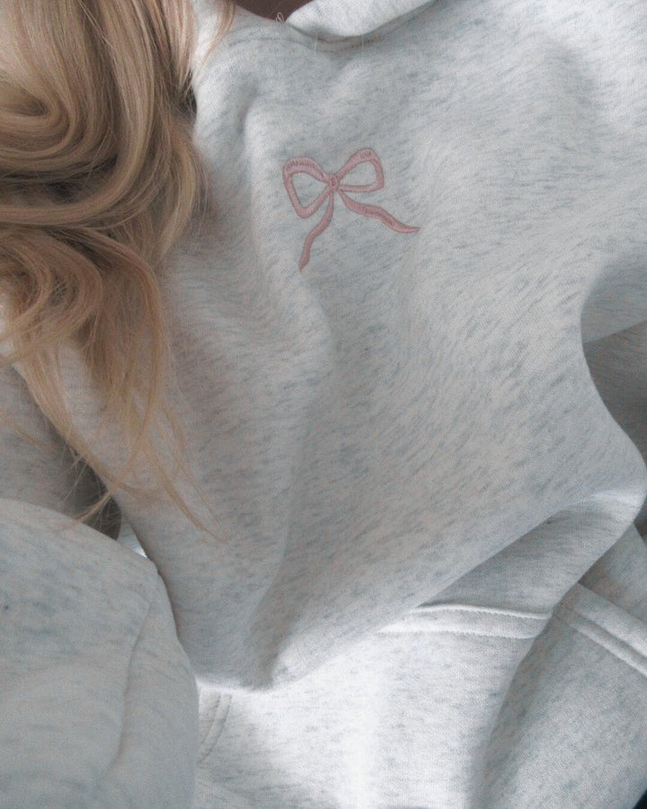 Light grey women's hoodie with floral lined hood and pink embroidery