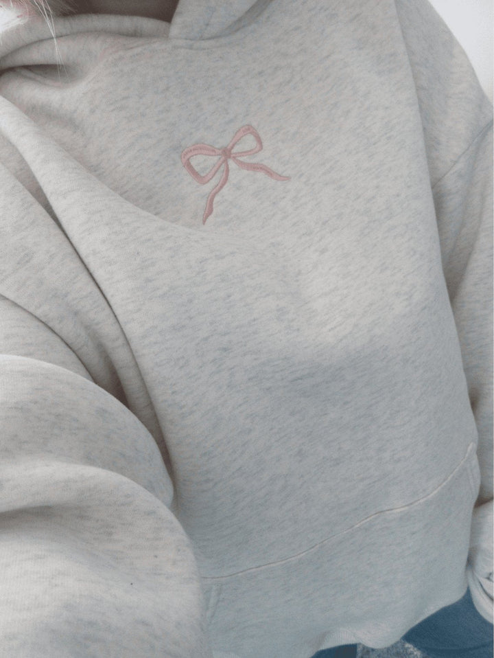 Light grey women's hoodie with floral lined hood and pink embroidery