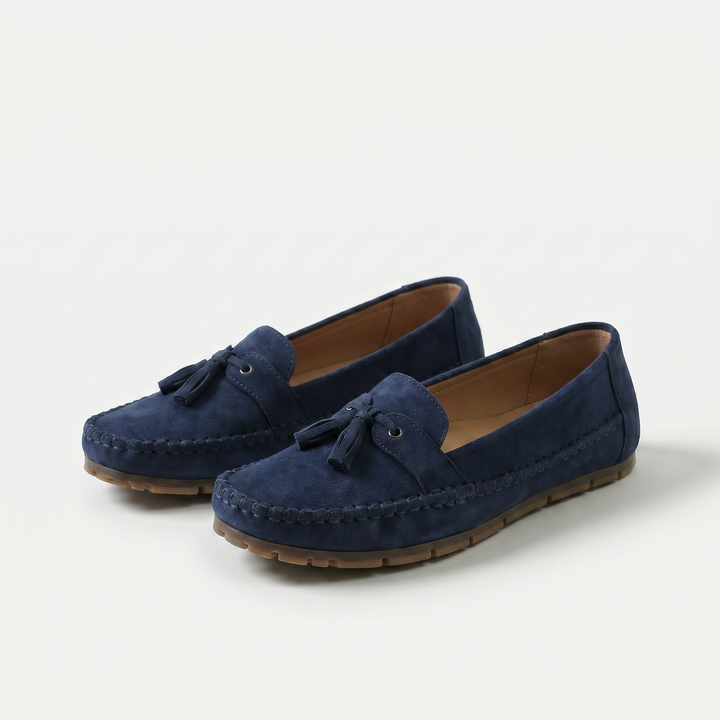 Women's slip-on tassel loafers with moccasin stitching and flat textured soles