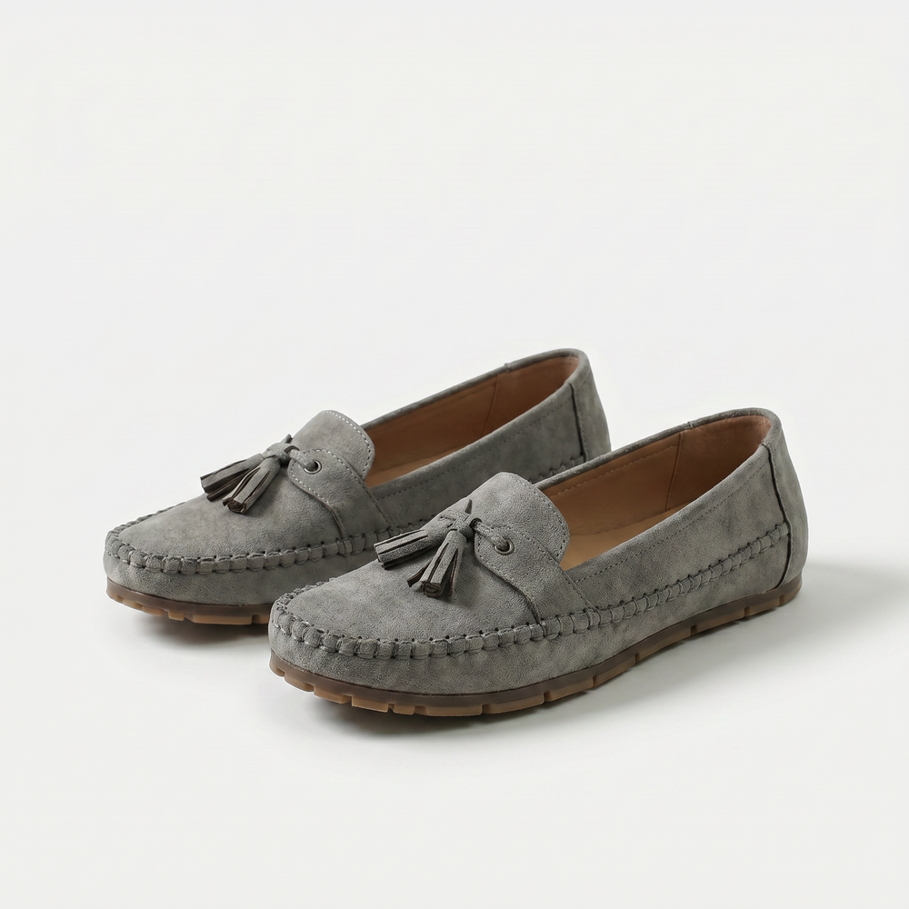 Women's slip-on tassel loafers with moccasin stitching and flat textured soles