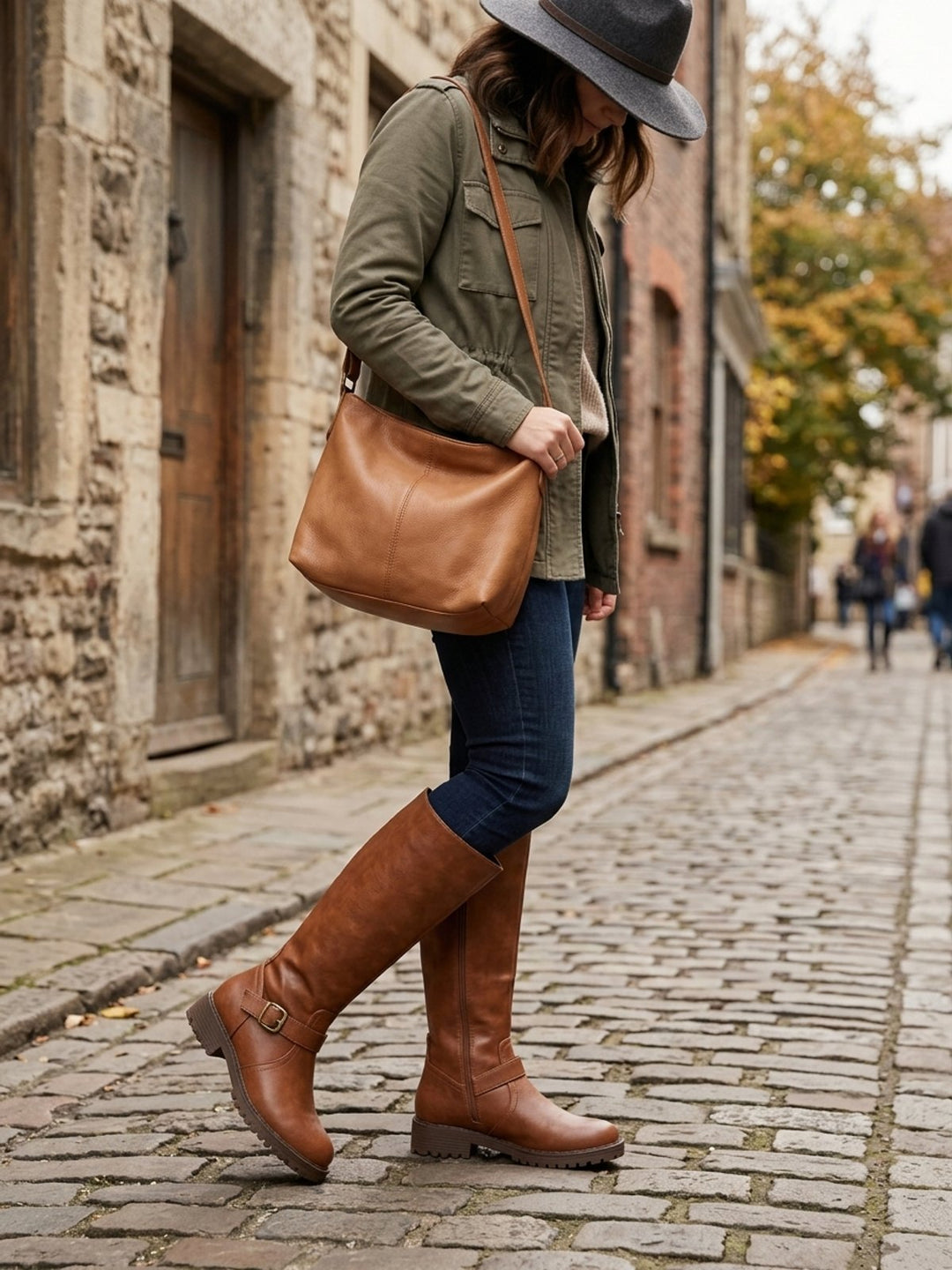 Women's knee-high boots with side zippers, buckle straps and lug soles