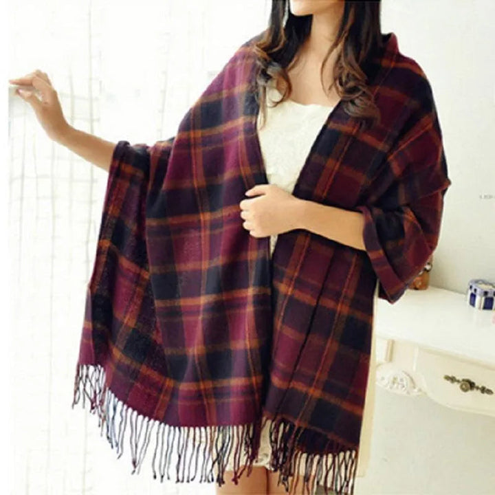 Women's checked fringe scarf worn as a draped shoulder wrap