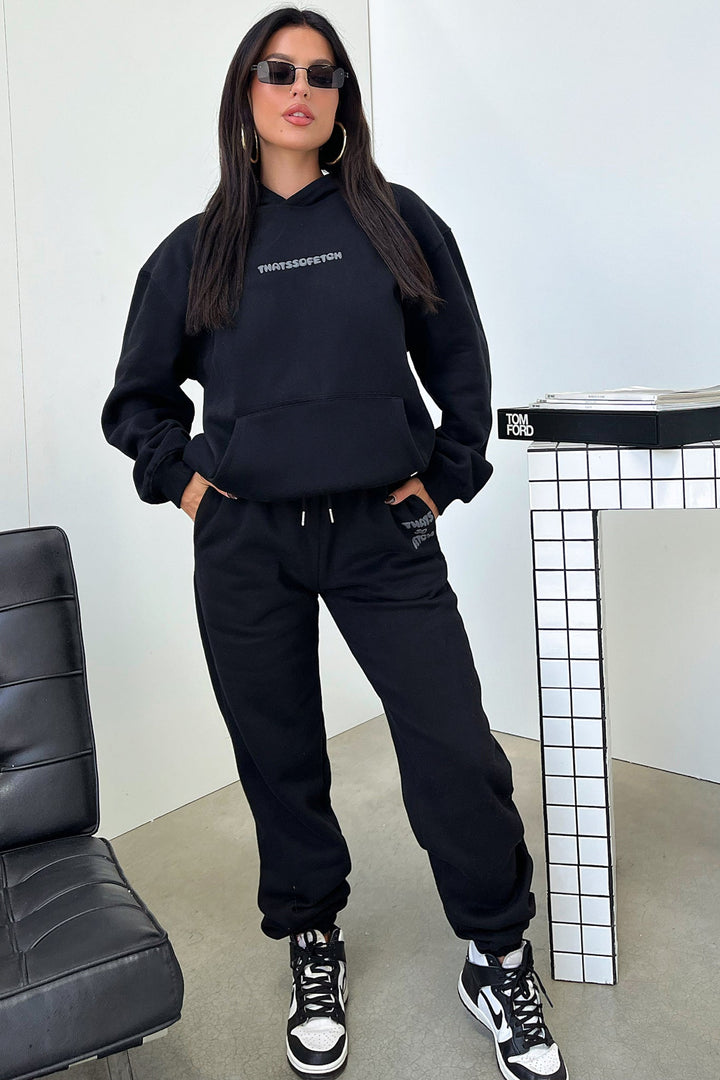 Women's black hooded sweatshirt with contrasting text graphic on the back