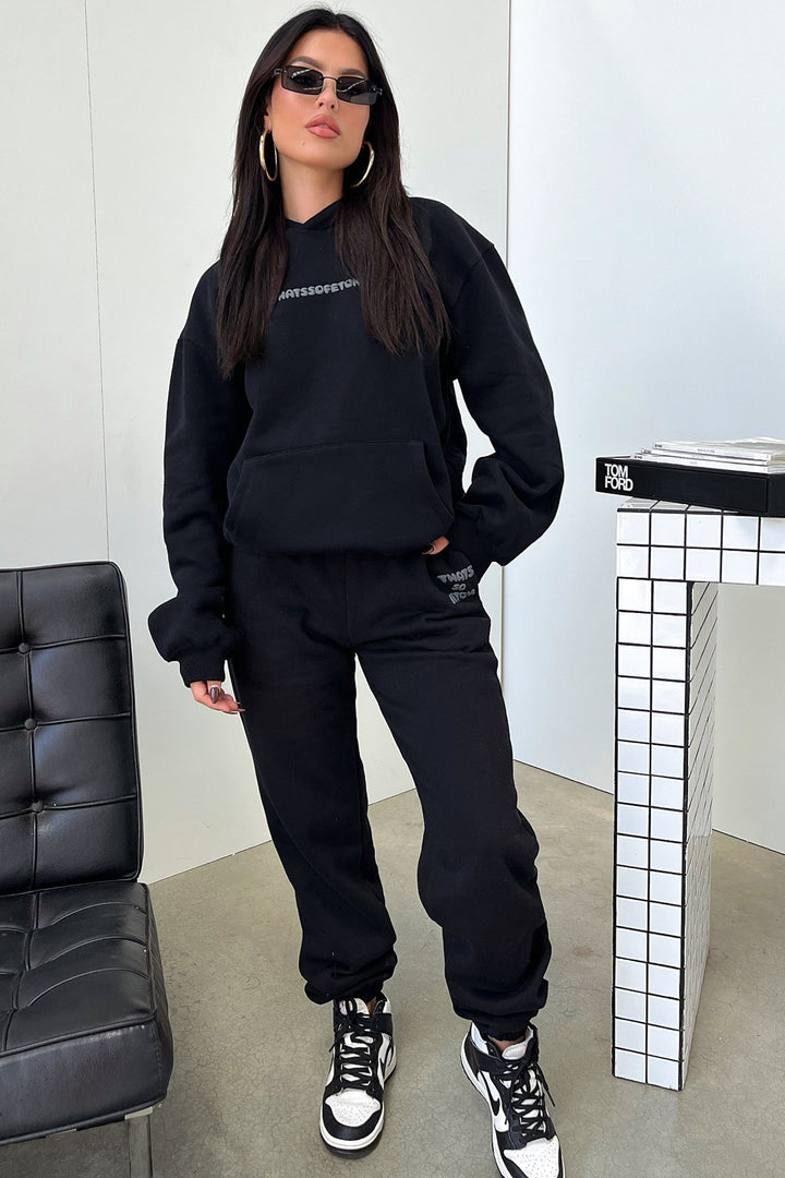 Women's black hooded sweatshirt with contrasting text graphic on the back
