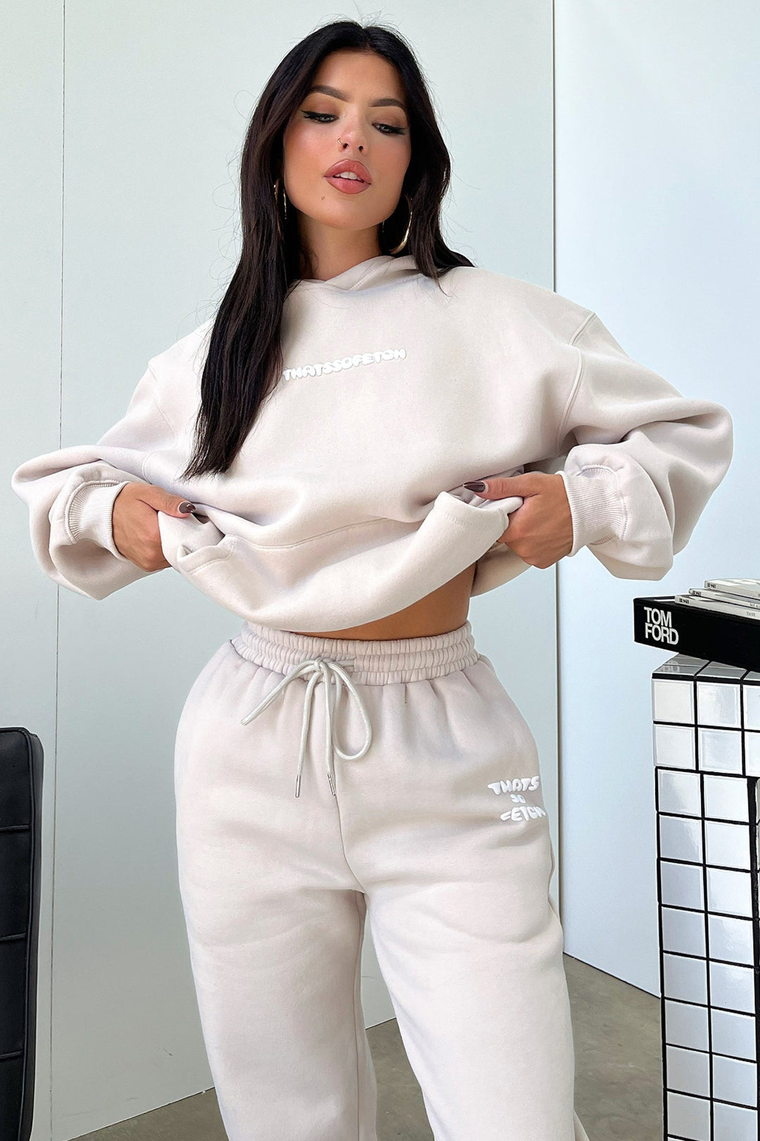 Women's beige cropped hoodie with hood, long sleeves, ribbed trims and chest lettering
