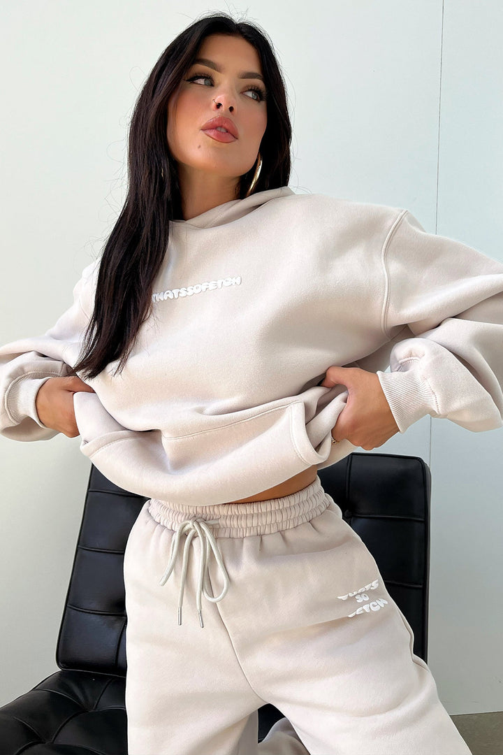 Women's beige cropped hoodie with hood, long sleeves, ribbed trims and chest lettering