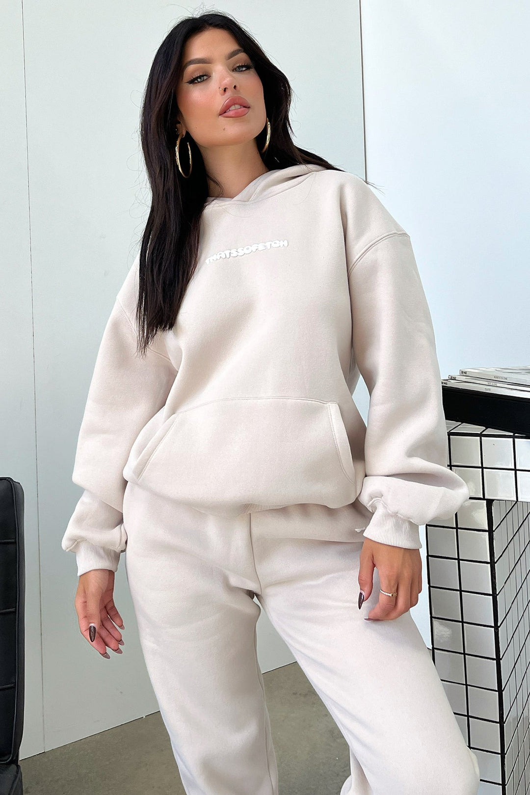 Women's beige cropped hoodie with hood, long sleeves, ribbed trims and chest lettering