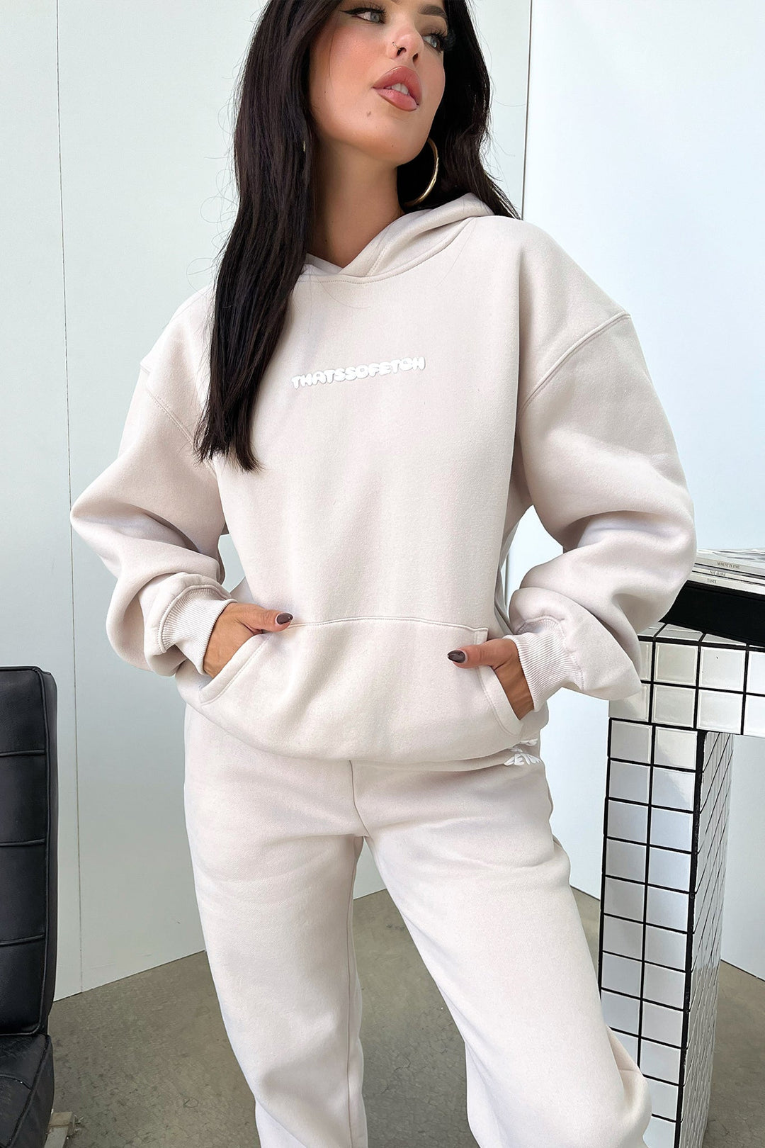 Women's beige cropped hoodie with hood, long sleeves, ribbed trims and chest lettering