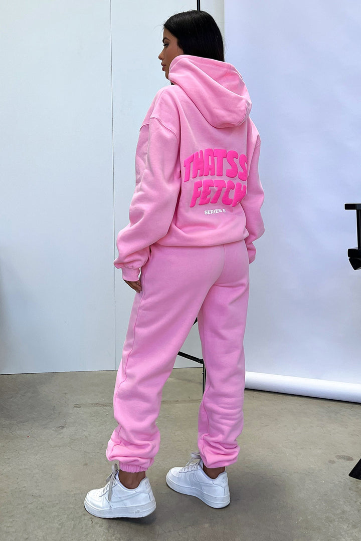 Women's pink cropped hoodie with long sleeves, front pouch pocket and chest graphic