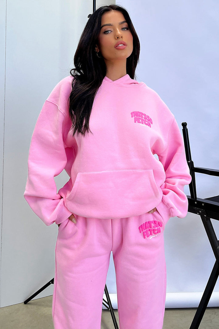 Women's pink cropped hoodie with long sleeves, front pouch pocket and chest graphic