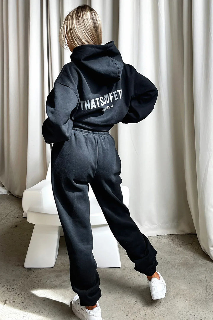 Women's black hooded sweatshirt with white chest graphic text