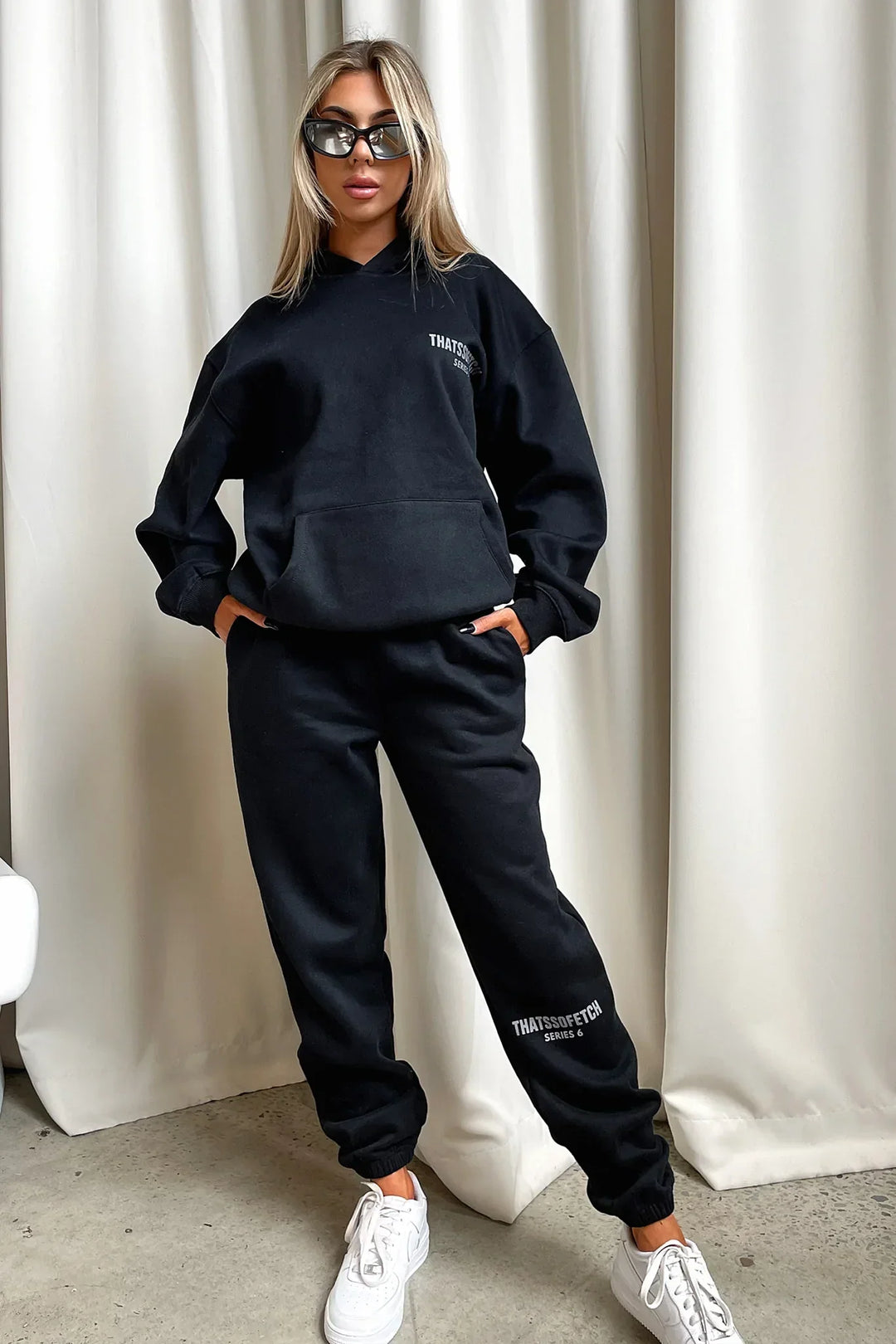 Women's black hooded sweatshirt with white chest graphic text