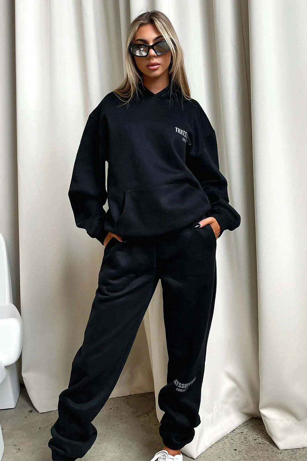 Women's black hooded sweatshirt with white chest graphic text