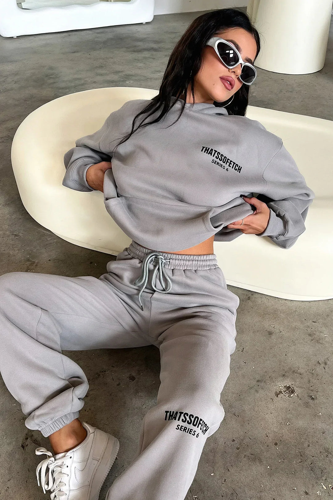 Women's grey hooded sweatshirt with long sleeves, front logo and ribbed trims