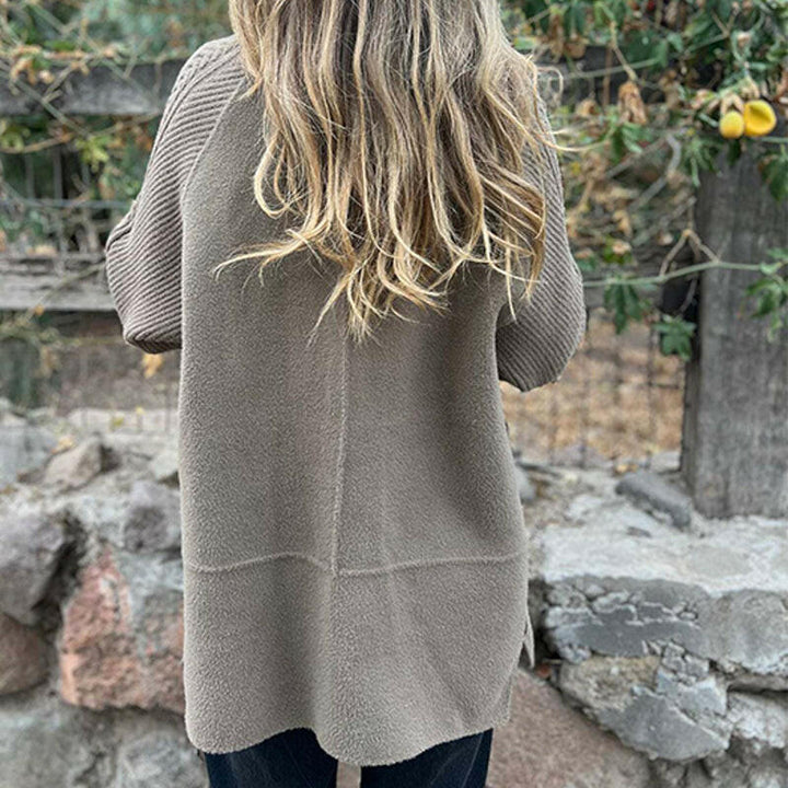 Women's double-breasted coat with long knit sleeves and buckle cuff details