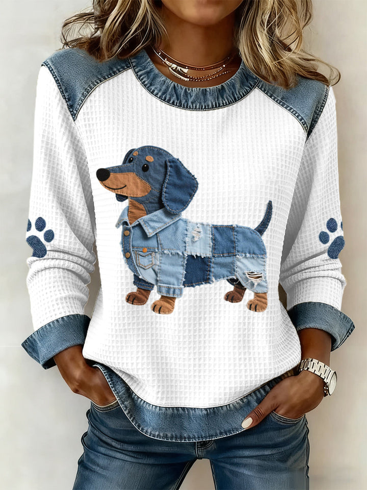 Women's blue and white sweatshirt with a patchwork dog graphic and paw-print sleeves