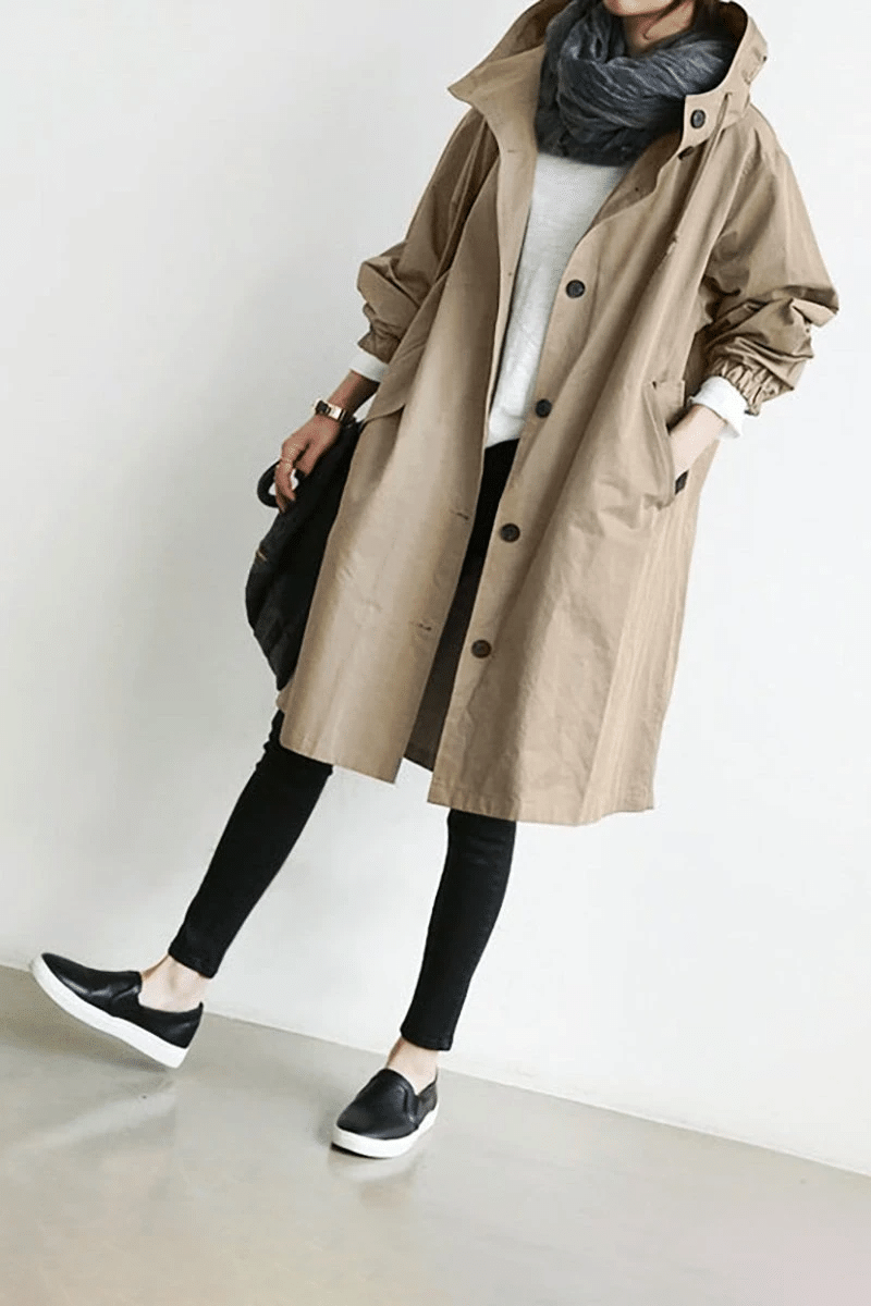 Women's long hooded button-front raincoat with side pockets