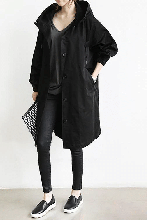 Women's long hooded button-front raincoat with side pockets