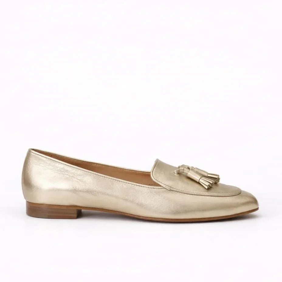 Women's metallic gold slip-on loafers with tassel detailing and low block heels