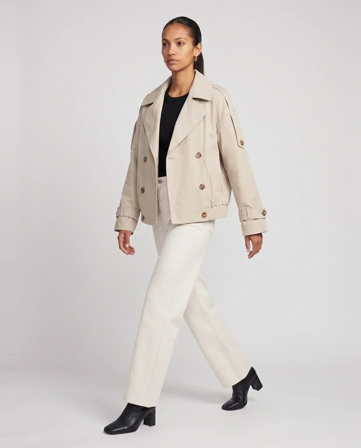 Women's beige short trench jacket with textured collar and button front