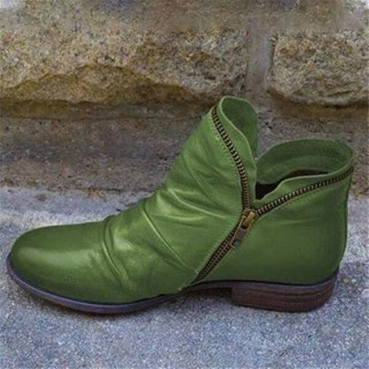 Ruched ankle boot with diagonal side zip, round toe and low heel