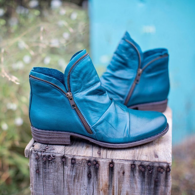 Ruched ankle boot with diagonal side zip, round toe and low heel