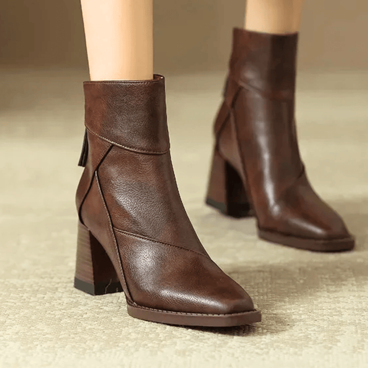 Women's pointed toe ankle boots with a high block heel and side tassel detail
