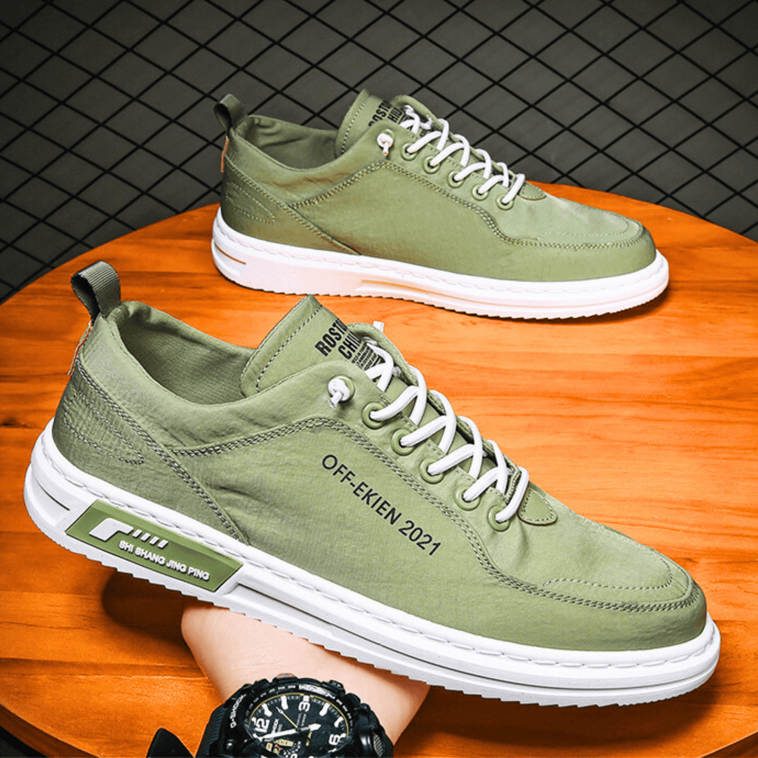 Low-top lace-up sneakers with stitched panels, contrast sole and rear pull tab