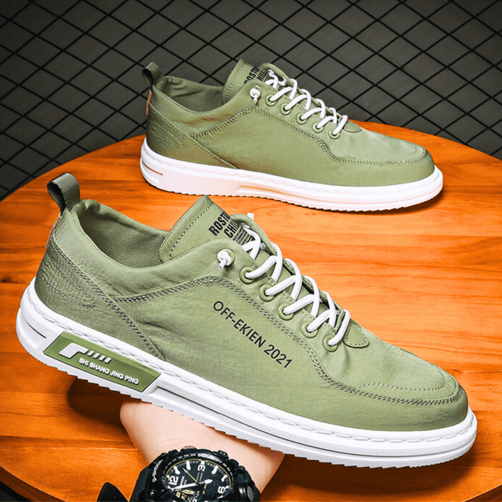 Low-top lace-up sneakers with stitched panels, contrast sole and rear pull tab