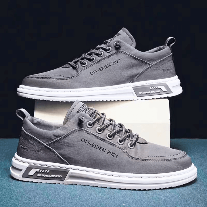 Low-top lace-up sneakers with stitched panels, contrast sole and rear pull tab