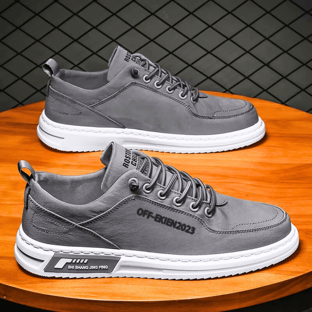 Low-top lace-up sneakers with stitched panels, contrast sole and rear pull tab