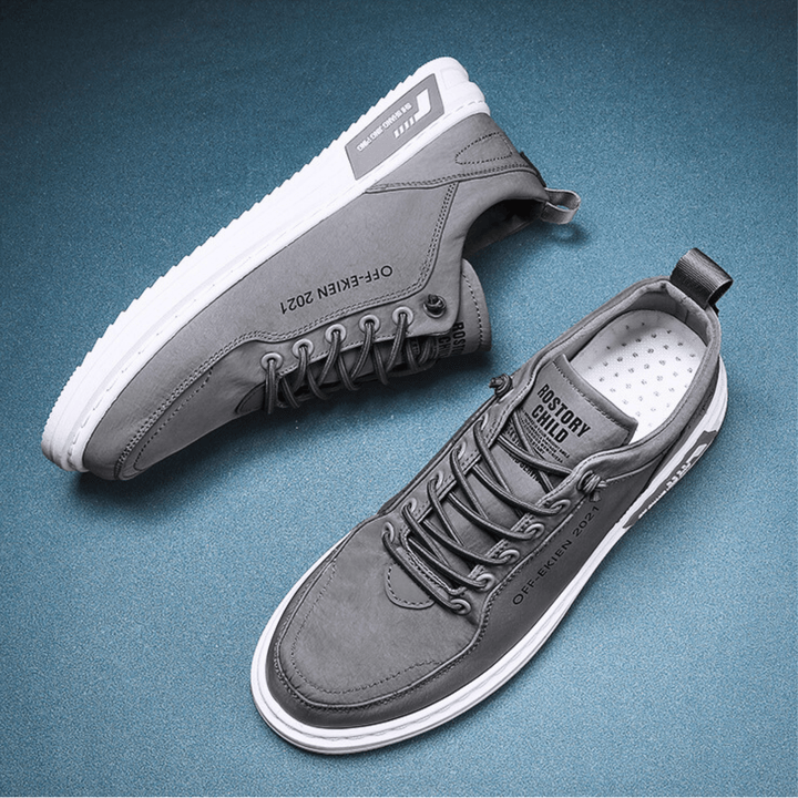 Low-top lace-up sneakers with stitched panels, contrast sole and rear pull tab