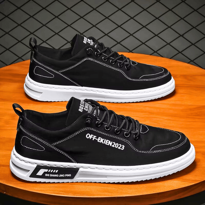 Low-top lace-up sneakers with stitched panels, contrast sole and rear pull tab
