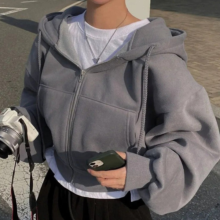 Women's cropped oversized hooded zip-up hoodie with drawstrings and front pockets