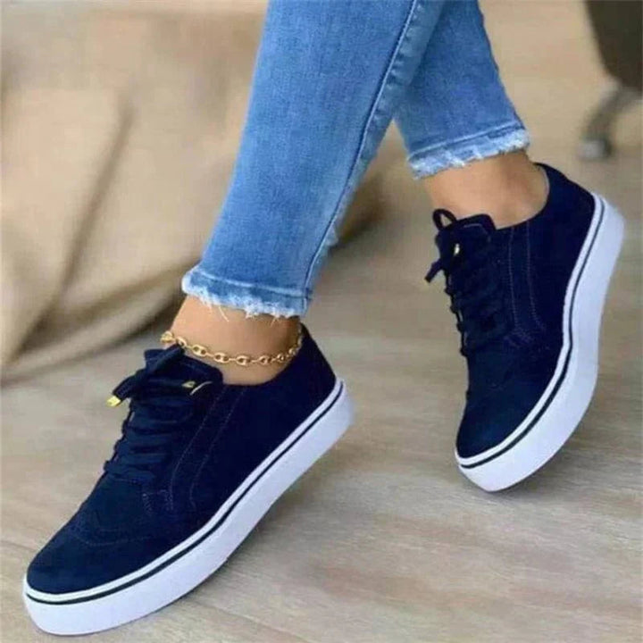 Women's low-top lace-up sneakers with perforated details and platform soles