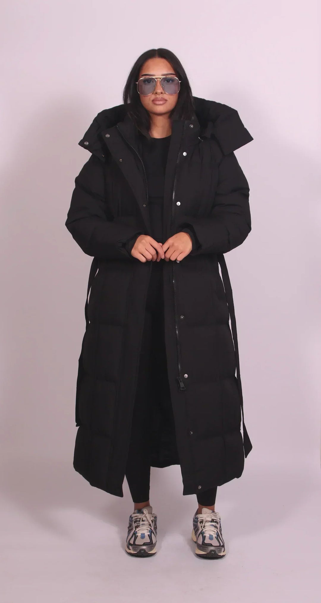 Women's oversized quilted longline puffer coat with hood and tie waist