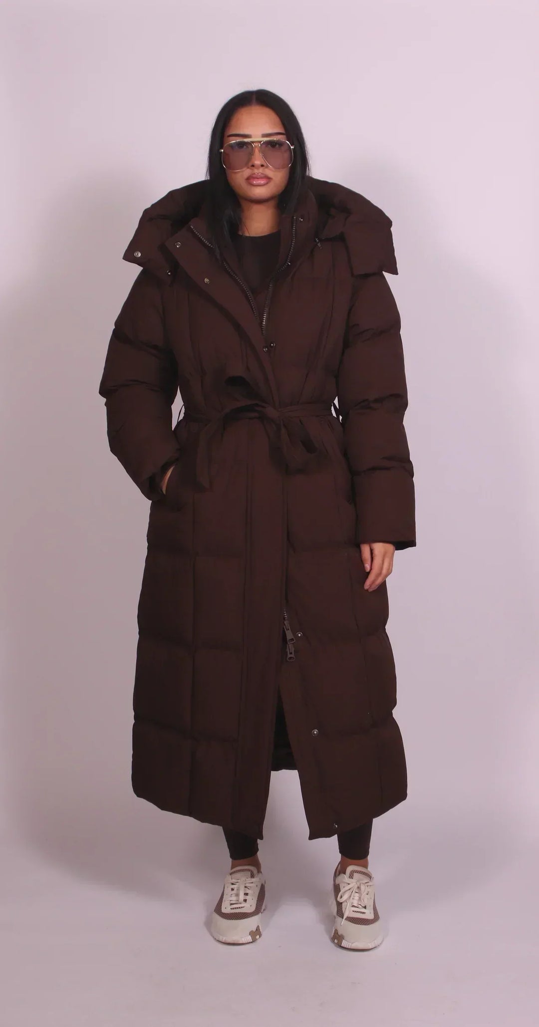 Women's oversized quilted longline puffer coat with hood and tie waist