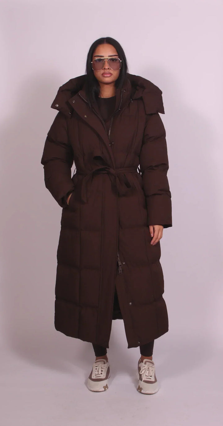 Women's oversized quilted longline puffer coat with hood and tie waist